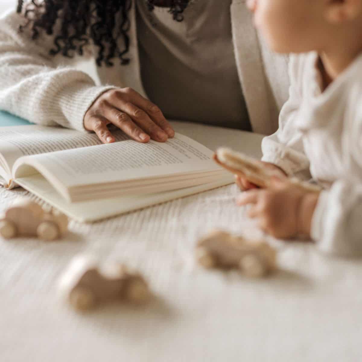 Book Holidays 2026 a woman reading a book beside her child.
