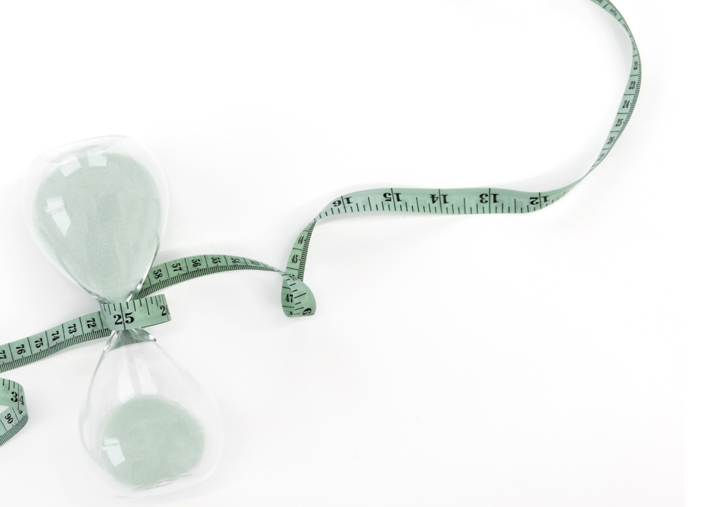 a measuring tape wrapped around an hourglass