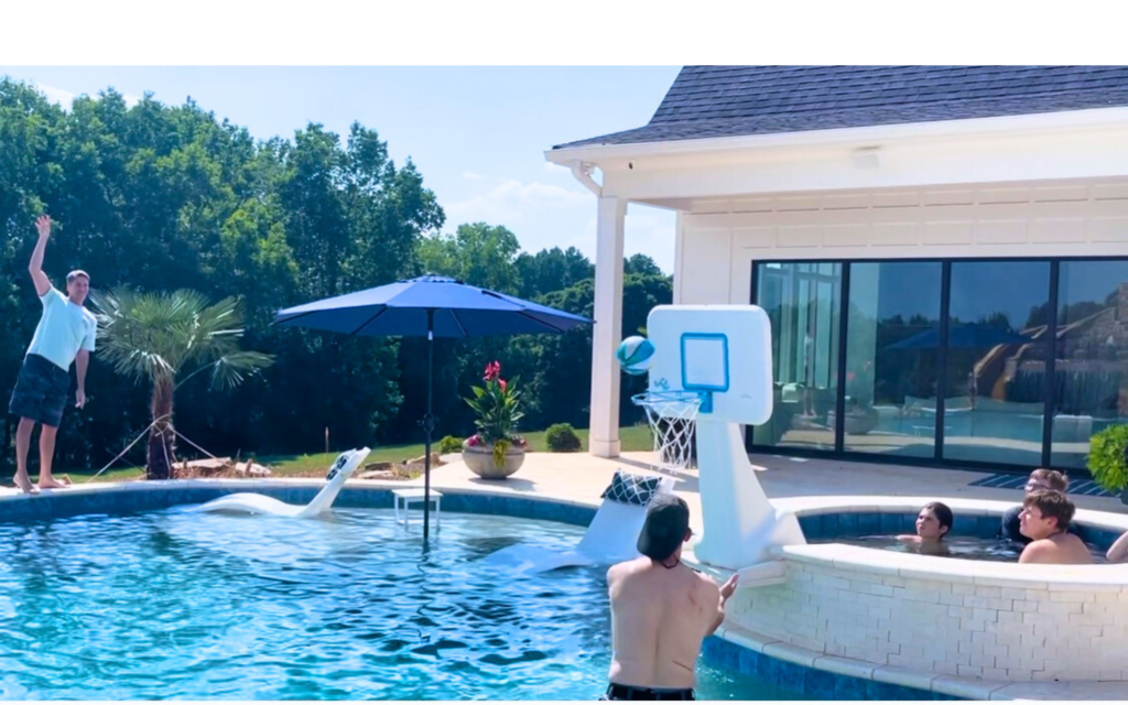 a man playing basketball in a pool