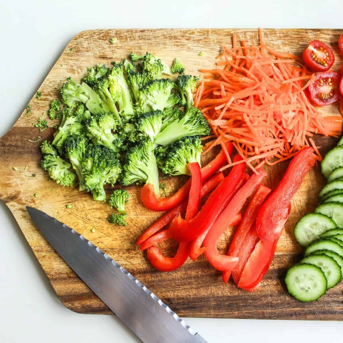 Meal Prep 101, chopped vegetables on a wooden board with knife