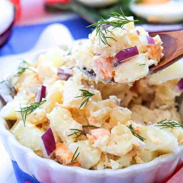Easy Potato Salad Recipe for Busy Moms. a bowl of potato salad with a wooden spoon