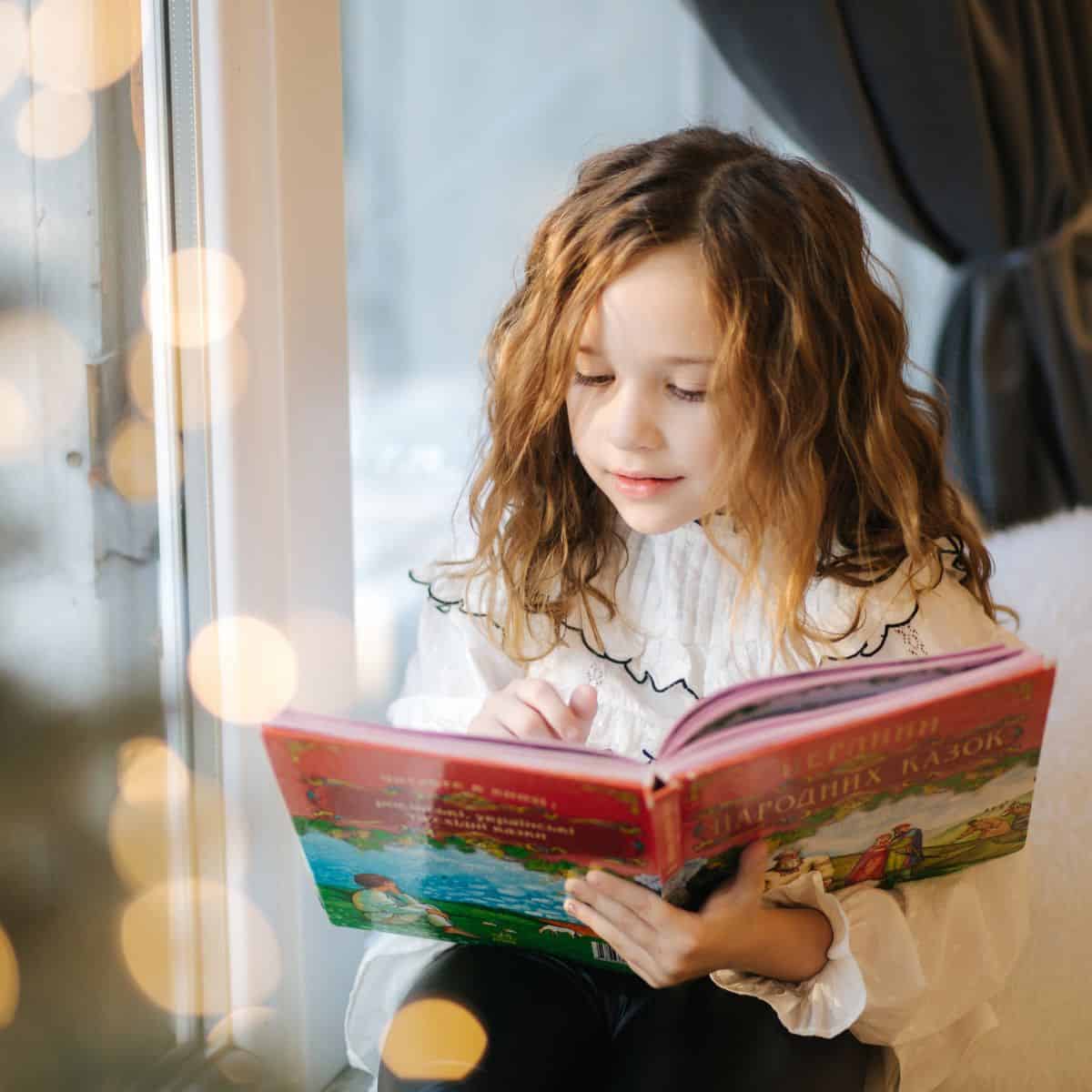 The Ultimate Guide to Book Holidays and Author Birthdays 2025, A girl reading a book