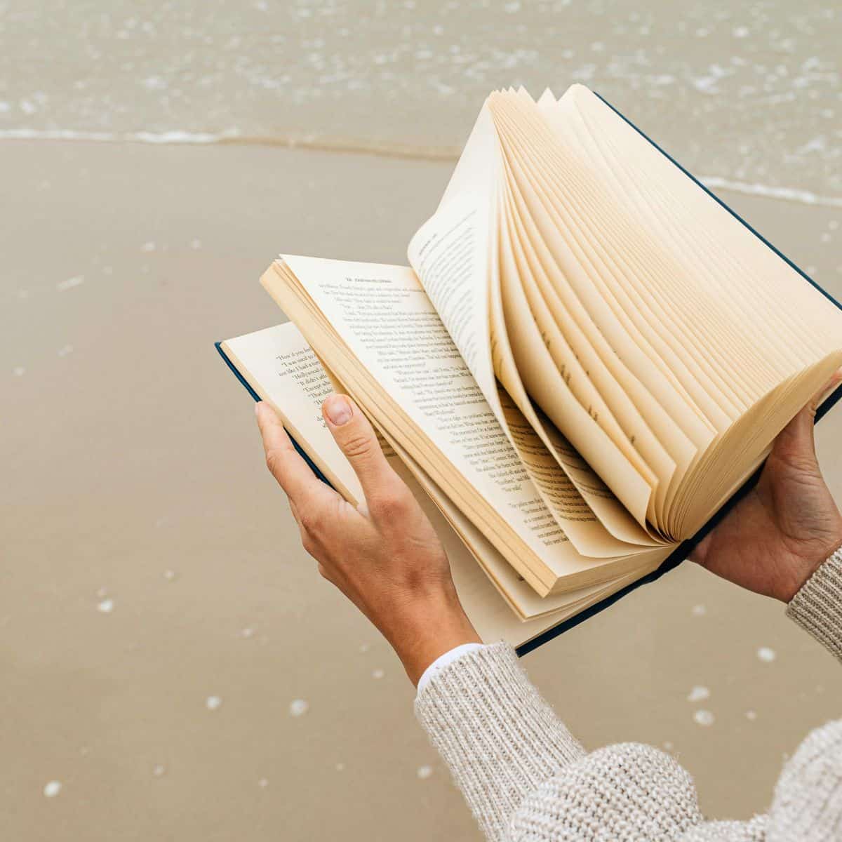 10 Ways for a Busy Mom to Start a Reading Habit, a person reading a book on the beach