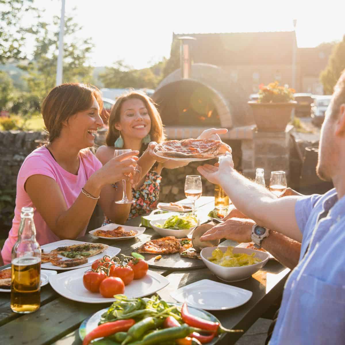 Summer Meal Plan, people sitting outside at a table of food.