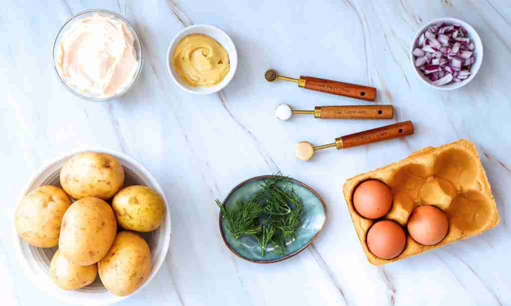 Ingredients for Potato Salad a table with food and utensils