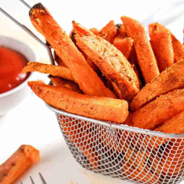 Air Fryer Sweet Potato Fries Recipe, a basket of fries with sauce