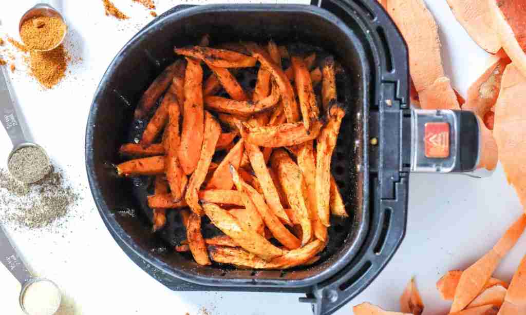Preheat the air fryer a black basket with orange fries