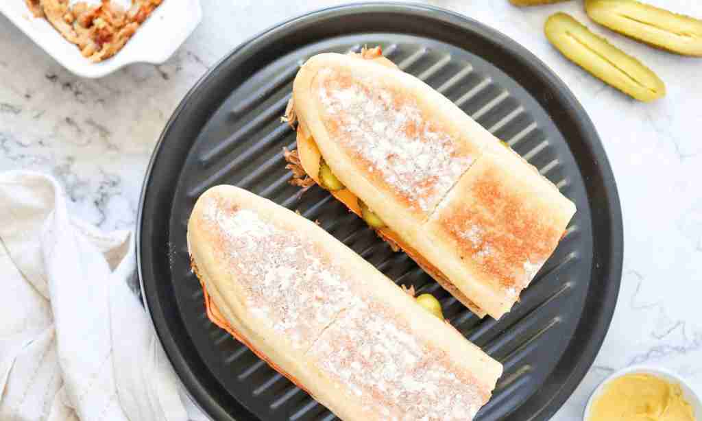 cuban sandwich two sandwiches on a grill