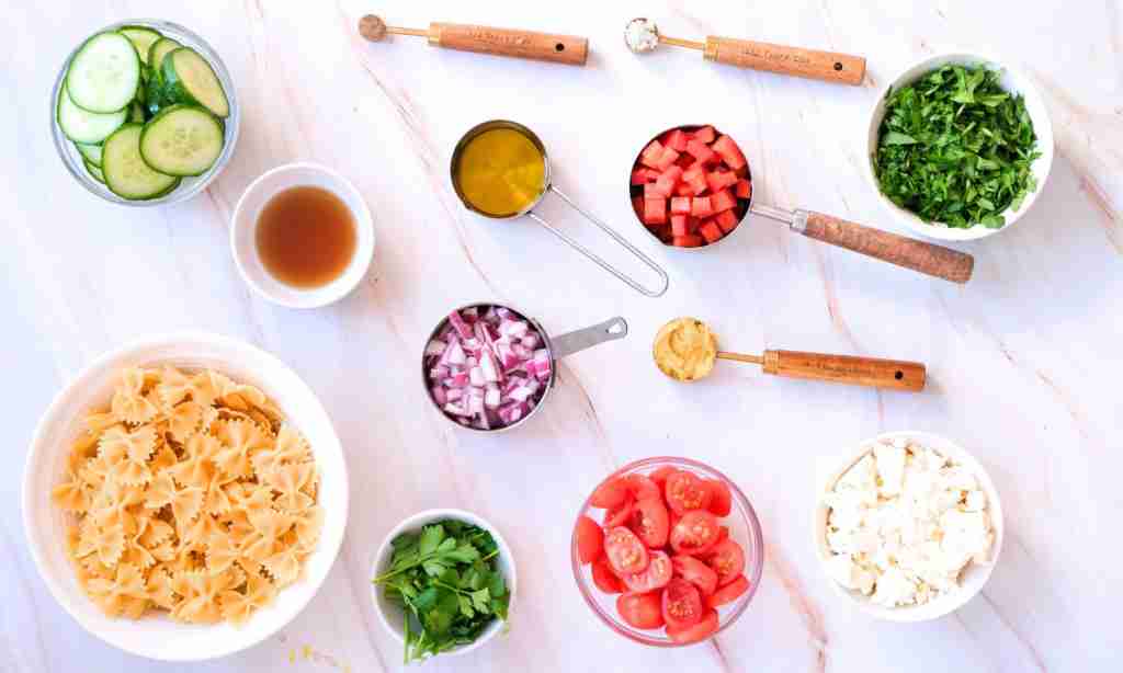 Pasta Salad ingredients a table with different kinds of food
