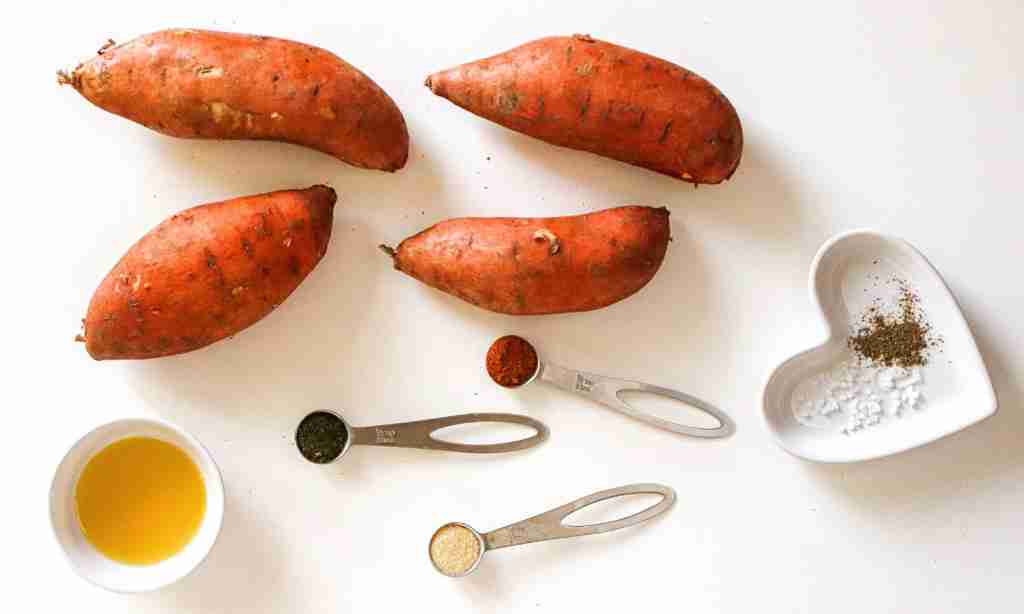 Air Fryer Sweet Potato Fries a group of sweet potatoes with measuring spoons and spices