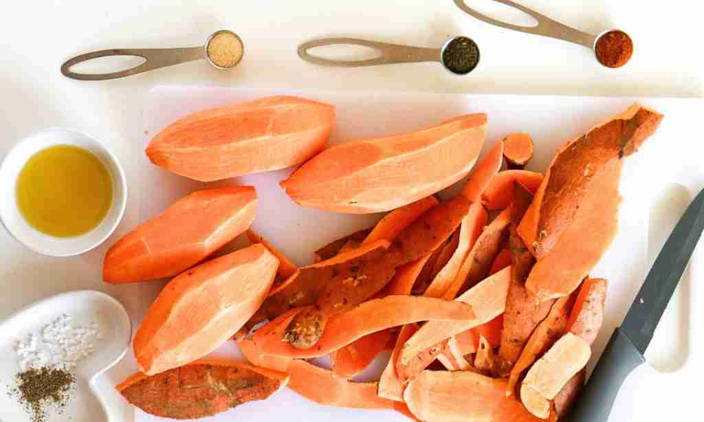 Cut up the sweet potatoes a pile of peeled sweet potatoes