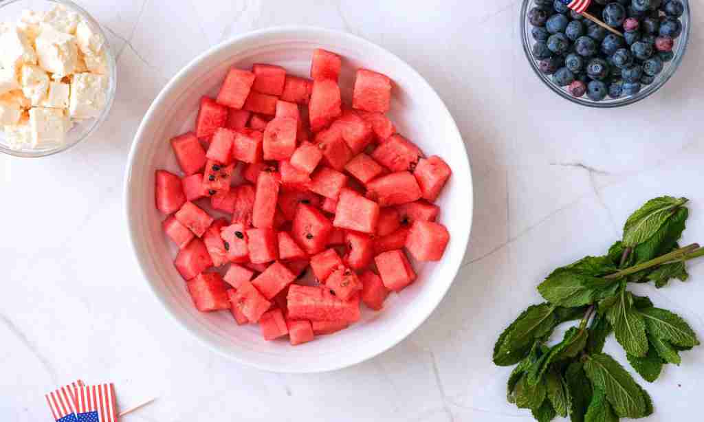 cut up watermelon into cubes a bowl of watermelon cubes