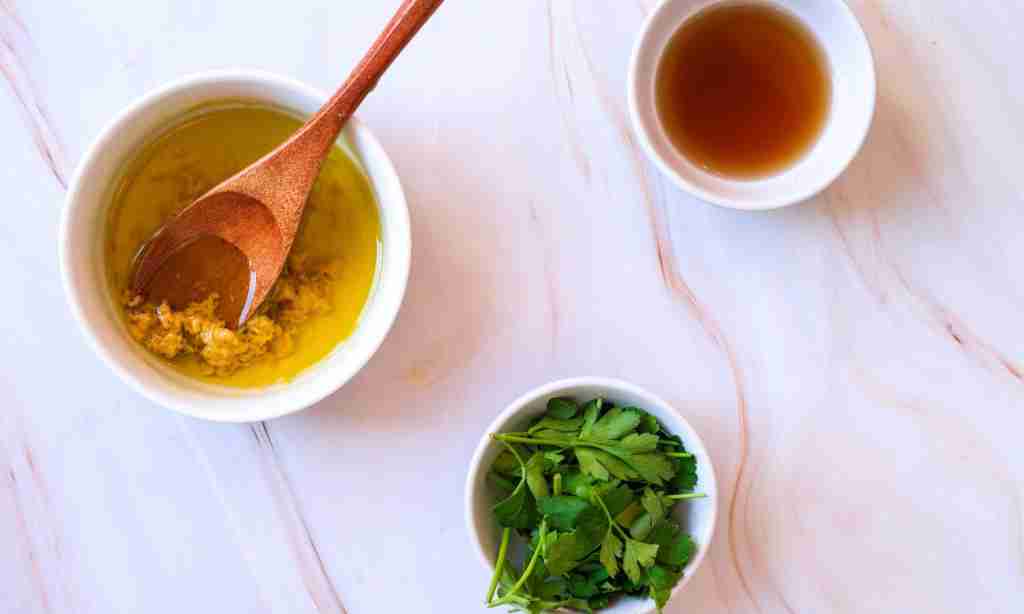 mix salad dressing a bowl of oil and a wooden spoon