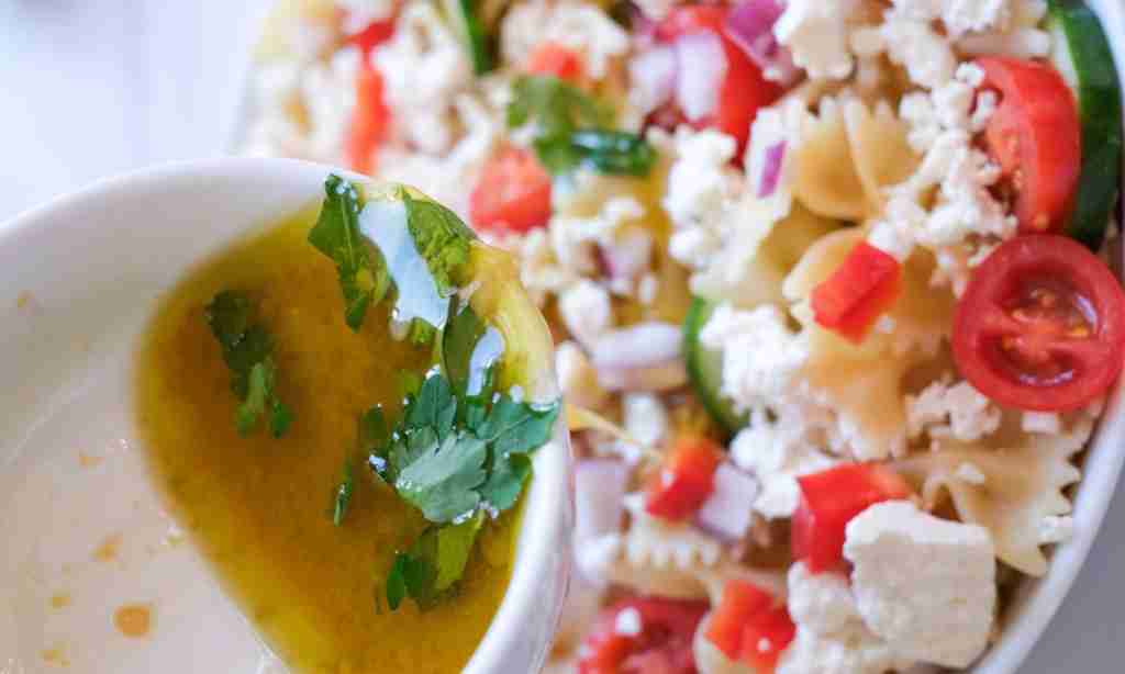 Dress the salad a bowl of soup next to pasta and vegetables