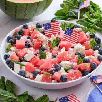 Watermelon Feta Salad. a bowl of watermelon salad with small flags