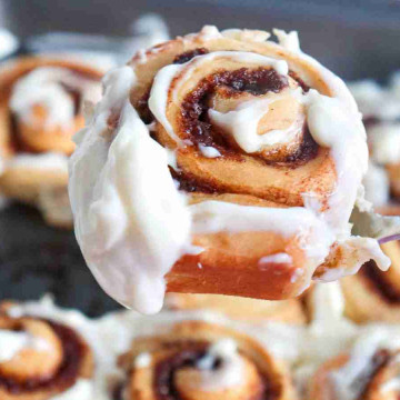 Cinnamon Rolls Recipe - a close up of a cinnamon roll on a fork