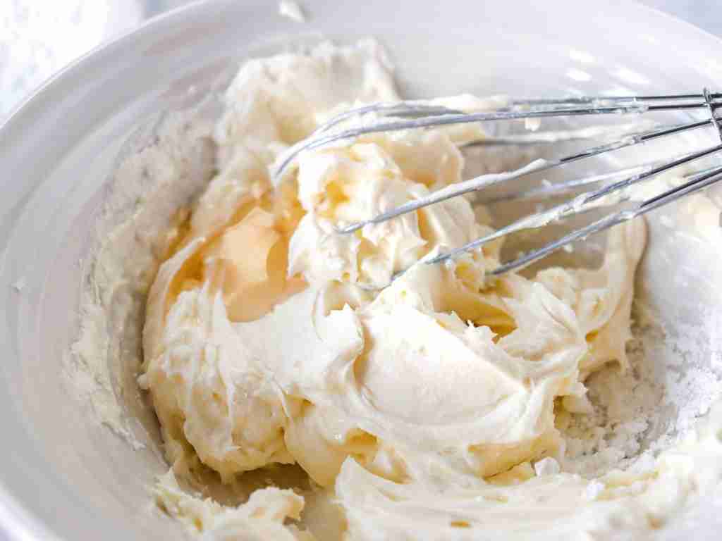 glaze a bowl of frosting with a whisk