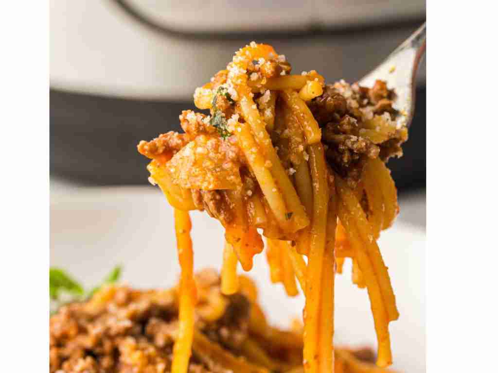 Instant Pot Spaghetti Recipe a fork holding spaghetti with meat and sauce