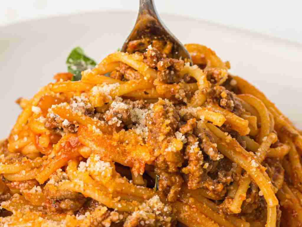 fork stirring spaghetti a fork in a bowl of spaghetti