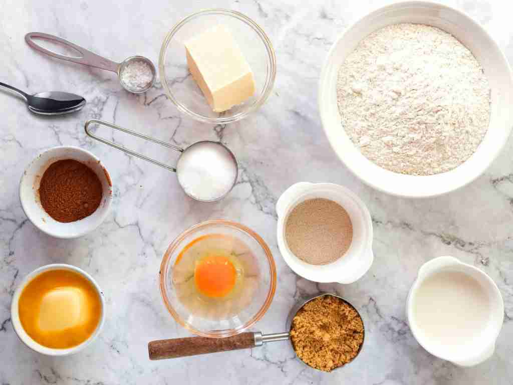 Cinnamon Rolls Recipe a group of ingredients on a marble surface