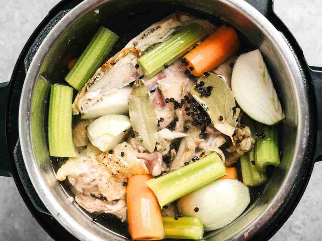Vegetables in an Instant Pot a pot of soup with vegetables and meat