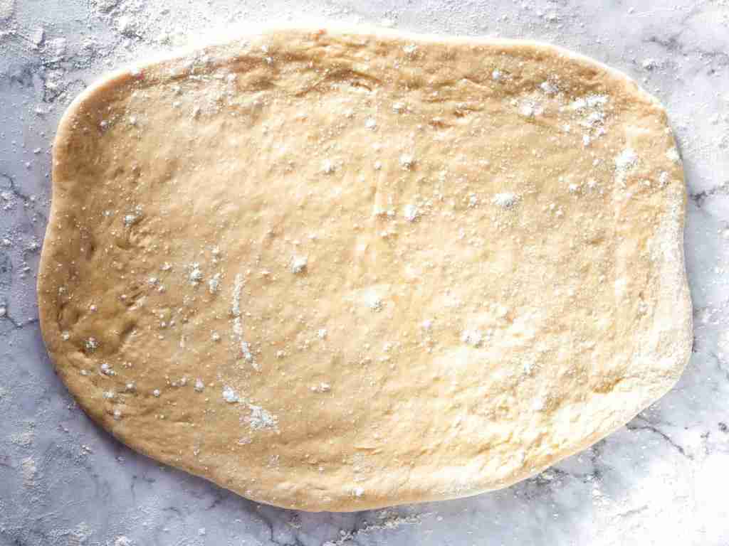 flatten out the dough flattened dough on a table