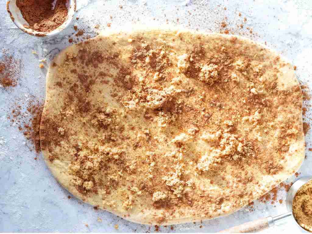 add the filling a dough with brown powder on it