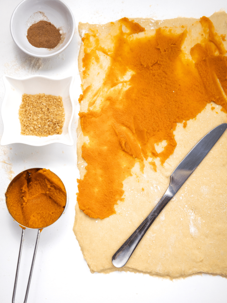 adding the filling Spices on rolled out dough