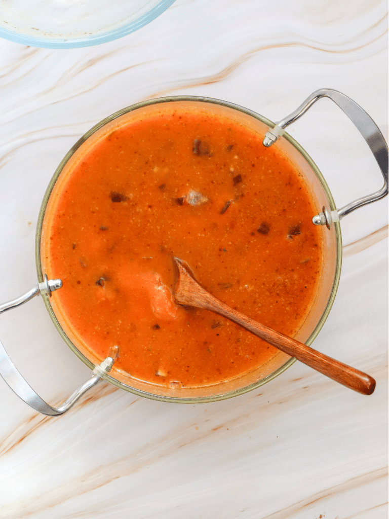 mix in the pumpkin puree Bowl of pumpkin soup with spoon