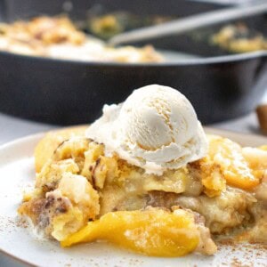 Skillet Peach Dump Cake with a scoop of vanilla icecream on top