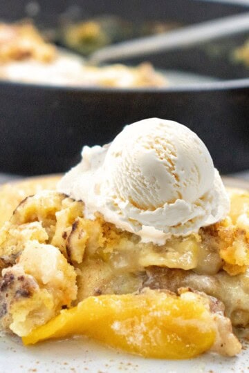 Skillet Peach Dump Cake with a scoop of vanilla icecream on top