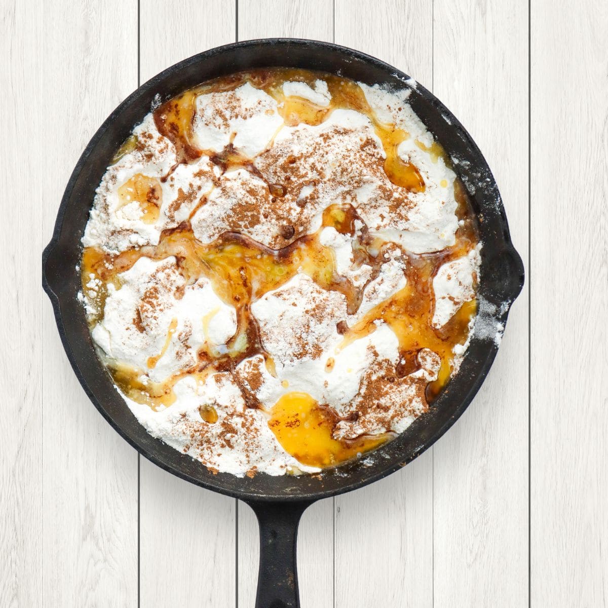 peach dump cake in a black skillet