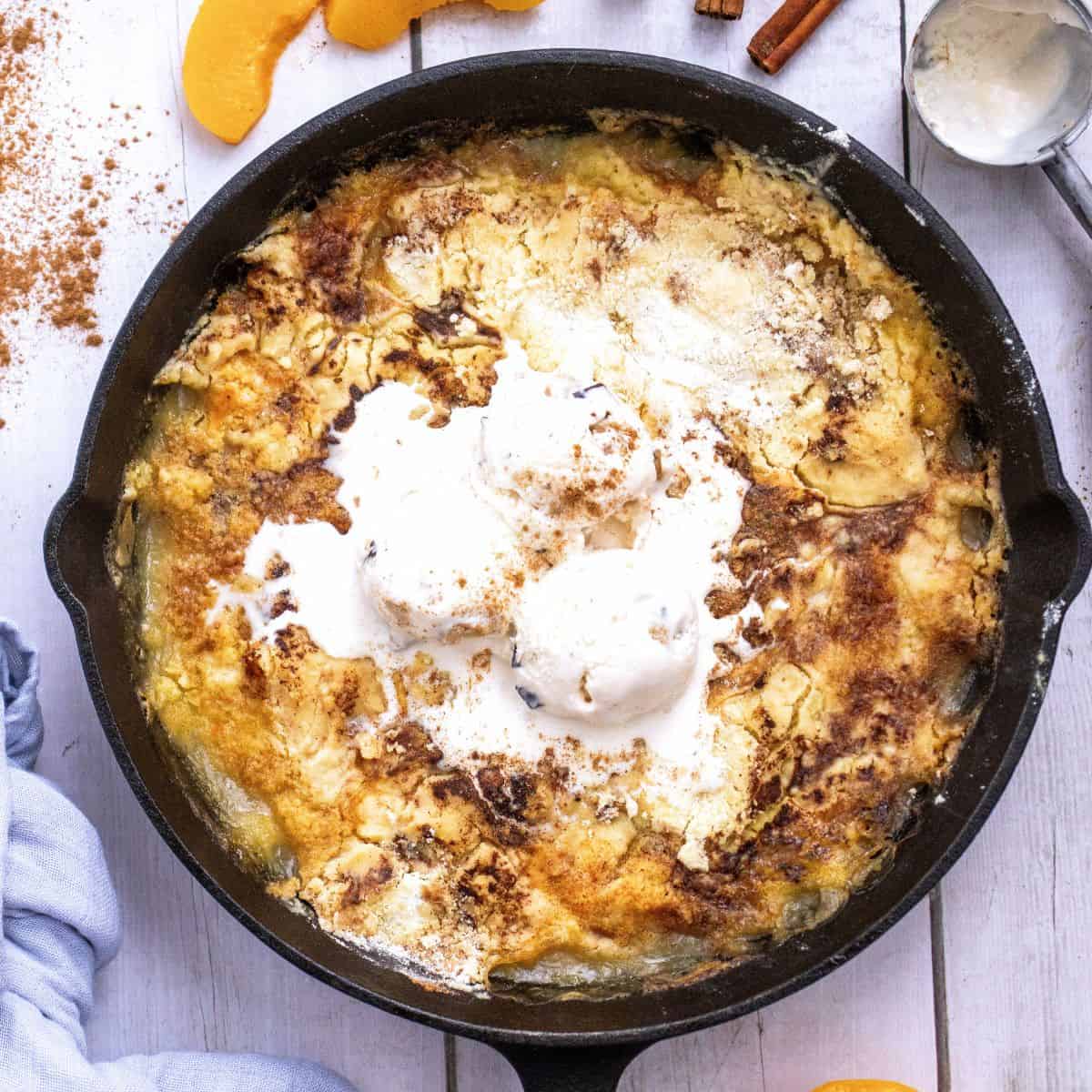 Step 5, Serve with ice cream or whipped cream cooked peach dump cake in a black skillet