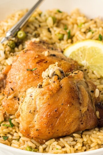 Instant Pot Chicken and Rice with a lemon wedge and a fork