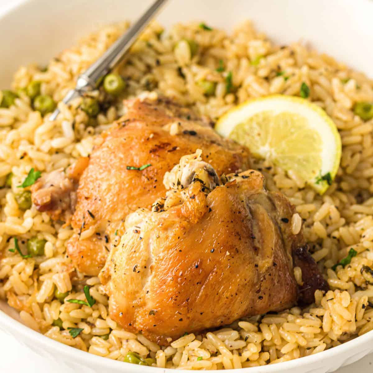 Instant Pot Chicken and Rice with a lemon wedge and a fork
