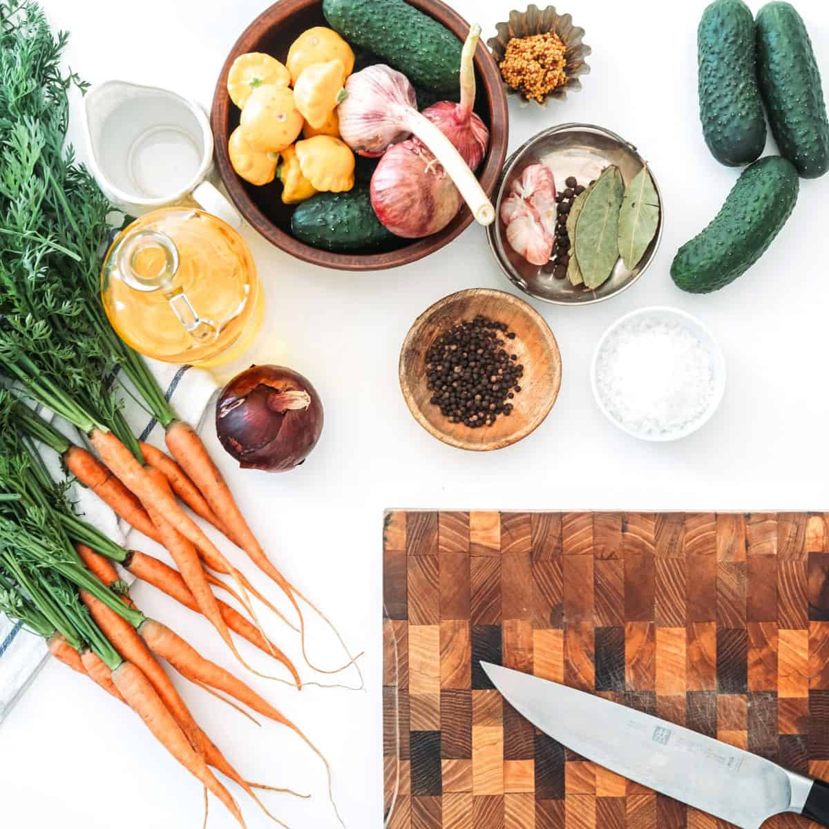 Save $200+ a Month on Groceries Without Clipping Coupons, Vegetables and a cutting board on a white kitchen counter